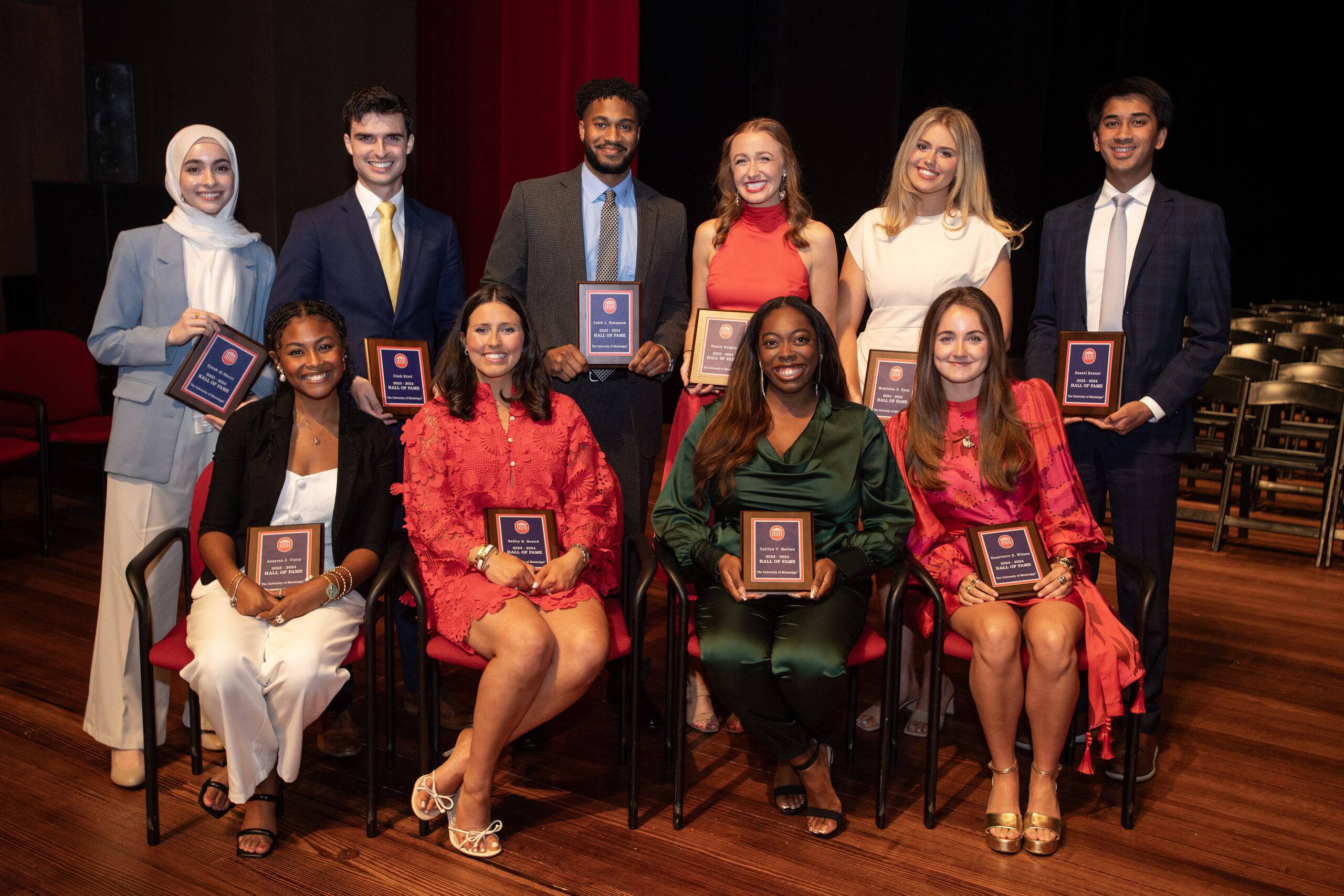 Ten Hall of Fame members posing on the Ford Center stage